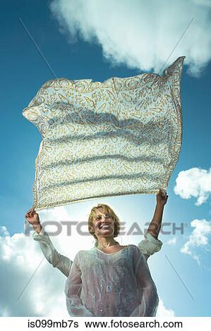 Person holding sarong in breeze over woman's head View Large Photo Image Stock Photograph - Person holding sarong in breeze over woman's head. Fotosearch