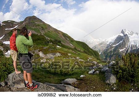 Photographing rainbow in mountains, White Rock Lakes, Ptarmigan Traverse, North Cascades, Washington, USA View Large Photo Image Stock Image - Photographing rainbow in mountains, White Rock Lakes, Ptarmigan Traverse, North Cascades, Washington, USA. Fotosearch