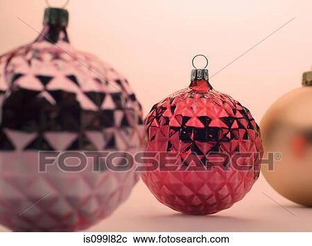 Stock Image - Pink and red Christmas baubles. Fotosearch