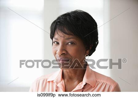 Stock Photography - Portrait of African American mature woman, studio shot. Fotosearch