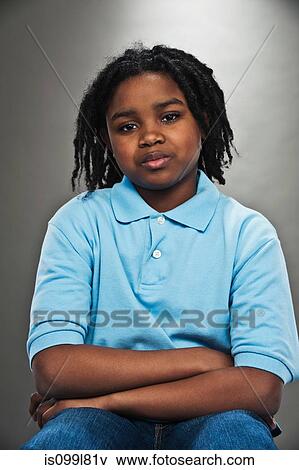 Stock Photo - Portrait of black teenage boy, studio shot. Fotosearch