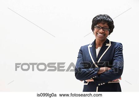 Stock Image - Portrait of mature African American businesswoman, studio shot. Fotosearch