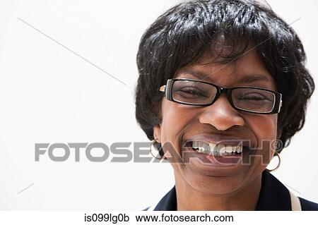 Stock Image - Portrait of mature African American businesswoman, studio shot. Fotosearch