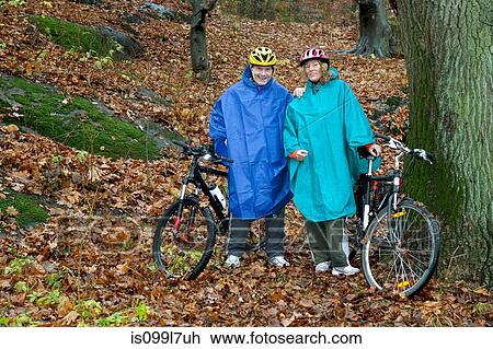 Portrait of mature couple on cycle ride in forest View Large Photo Image Stock Image - Portrait of mature couple on cycle ride in forest. Fotosearch