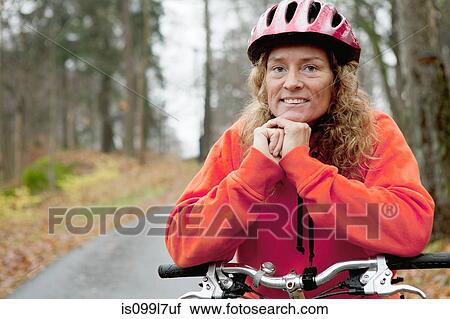 Portrait of mature woman on cycle ride View Large Photo Image Stock Image - Portrait of mature woman on cycle ride. Fotosearch