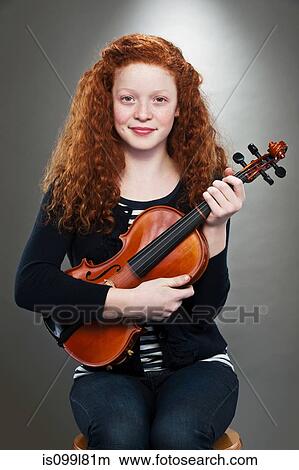 Portrait of mixed race teenage girl holding violin View Large Photo Image Picture - Portrait of mixed race teenage girl holding violin. Fotosearch