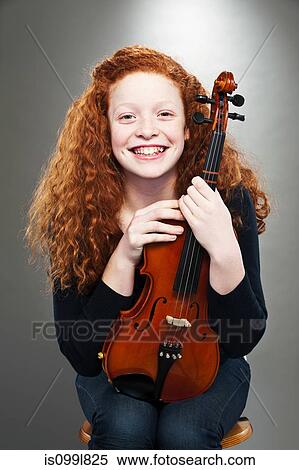Portrait of mixed race teenage girl holding violin View Large Photo Image Stock Photography - Portrait of mixed race teenage girl holding violin. Fotosearch