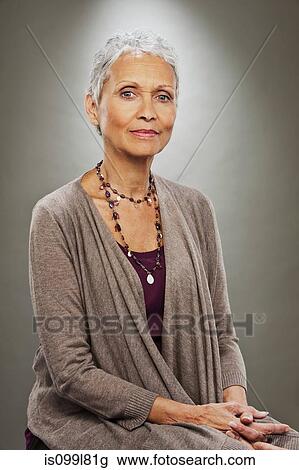 Portrait of senior woman smiling, studio shot View Large Photo Image Stock Image - Portrait of senior woman smiling, studio shot. Fotosearch