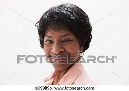 Picture - Portrait of smiling African American mature woman, studio shot. Fotosearch