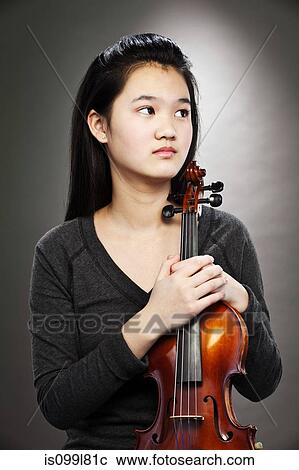Portrait of young Asian teenage girl holding violin View Large Photo Image Stock Image - Portrait of young Asian teenage girl holding violin. Fotosearch