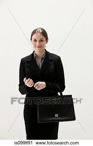 Portrait of young businesswoman smiling, studio shot View Large Photo Image Stock Image - Portrait of young businesswoman smiling, studio shot. Fotosearch