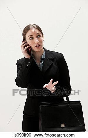 Portrait of young businesswoman using cellphone, studio shot View Large Photo Image Stock Image - Portrait of young businesswoman using cellphone, studio shot. Fotosearch