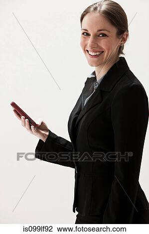 Portrait of young businesswoman using cellphone, studio shot View Large Photo Image Stock Image - Portrait of young businesswoman using cellphone, studio shot. Fotosearch