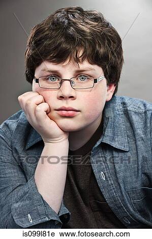 Stock Image - Portrait of young teenage boy wearing spectacles. Fotosearch