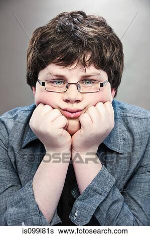 Portrait of young teenage boy with hands on chin View Large Photo Image Stock Photograph - Portrait of young teenage boy with hands on chin. Fotosearch