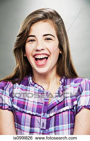 Portrait of young teenage girl laughing, studio shot View Large Photo Image Stock Photograph - Portrait of young teenage girl laughing, studio shot. Fotosearch