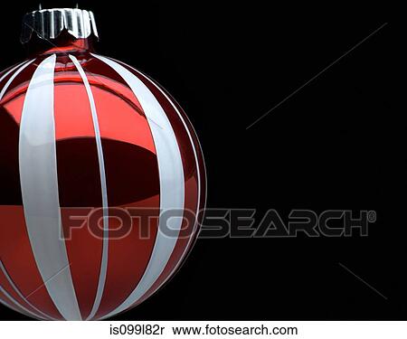 Stock Photography - Red and white Christmas bauble, studio shot. Fotosearch