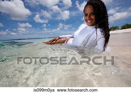 Stock Image - Relaxing in Shallow Water. Fotosearch
