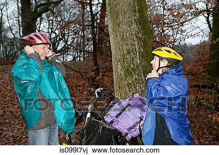Senior couple preparing to cycle in forest View Large Photo Image Stock Image - Senior couple preparing to cycle in forest. Fotosearch