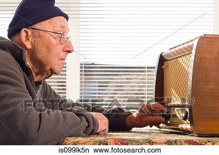 Picture - Senior man tuning radio, close up. Fotosearch