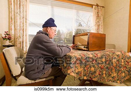 Picture - Senior man tuning radio. Fotosearch