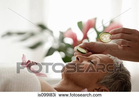 Stock Image - Senior woman relaxing on massage table. Fotosearch