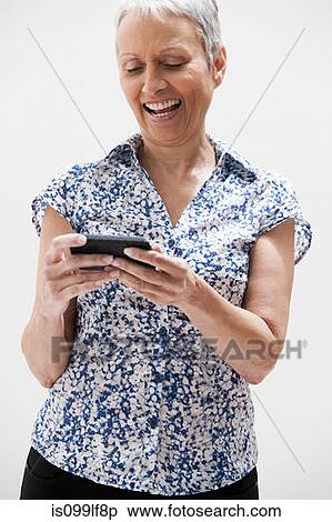 Senior woman using cellphone, studio shot View Large Photo Image Stock Photography - Senior woman using cellphone, studio shot. Fotosearch