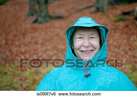 Stock Photograph - Senior woman wearing waterproof clothing and smiling. Fotosearch