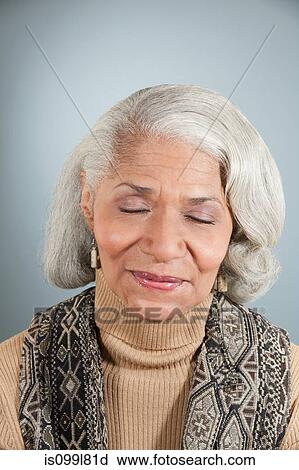 Stock Image - Senior woman with eyes closed. Fotosearch