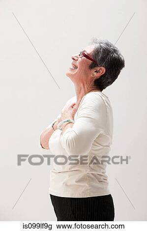 Side view of mature woman smiling, studio shot View Large Photo Image Stock Image - Side view of mature woman smiling, studio shot. Fotosearch