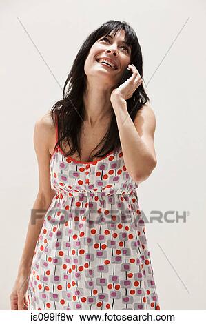 Smiling mature woman using cellphone, studio shot View Large Photo Image Stock Photo - Smiling mature woman using cellphone, studio shot. Fotosearch