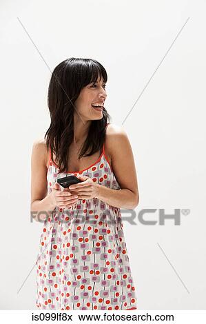 Smiling mature woman using cellphone, studio shot View Large Photo Image Stock Photo - Smiling mature woman using cellphone, studio shot. Fotosearch
