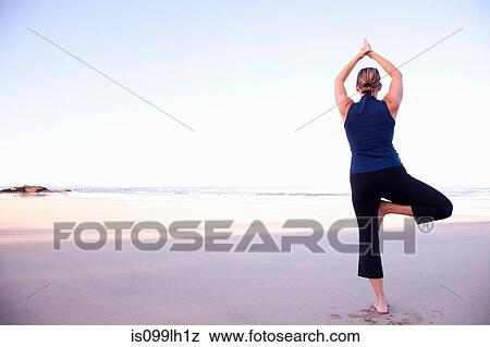 Stock Photo - Woman doing yoga on beach, Playa Grande, Santa Cruz, Costa Rica. Fotosearch