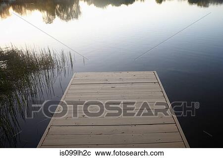 Stock Image - Wooden jetty and lake. Fotosearch