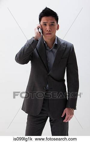Young Asian businessman using cellphone, studio shot View Large Photo Image Stock Image - Young Asian businessman using cellphone, studio shot. Fotosearch