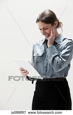 Young businesswoman using digital tablet, studio shot View Large Photo Image Stock Photo - Young businesswoman using digital tablet, studio shot. Fotosearch