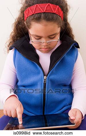 Young girl using digital tablet View Large Photo Image Stock Image - Young girl using digital tablet. Fotosearch