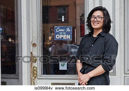 Young male worker outside cafe View Large Photo Image Stock Photo - Young male worker outside cafe. Fotosearch