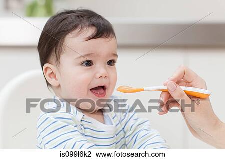Baby boy being fed View Large Photo Image Stock Image - Baby boy being fed. Fotosearch