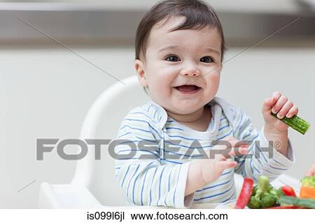 Baby boy eating healthy vegetables View Large Photo Image Stock Image - Baby boy eating healthy vegetables. Fotosearch