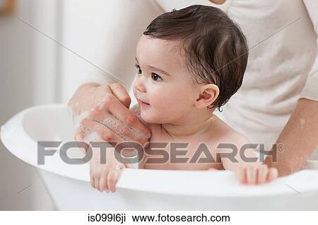 Stock Image - Baby boy having a bath. Fotosearch