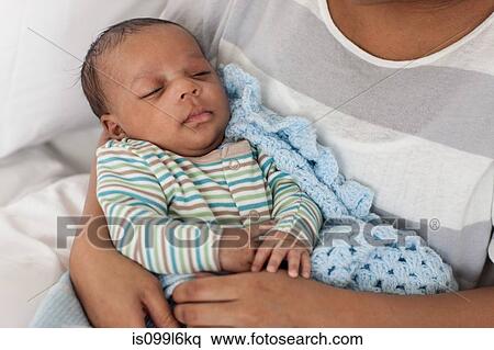 Baby boy in mother's arms View Large Photo Image Stock Photography - Baby boy in mother's arms. Fotosearch