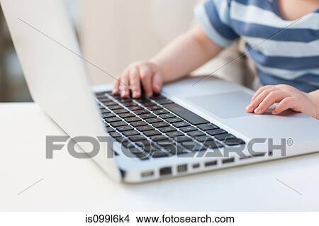 Picture - Baby using a laptop. Fotosearch