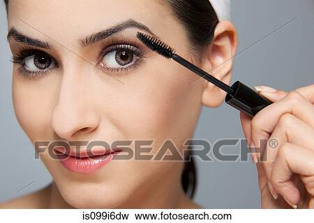 Beautiful woman applying mascara View Large Photo Image Stock Photo - Beautiful woman applying mascara. Fotosearch