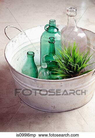 Bottles and plant in an old tub View Large Photo Image Stock Photography - Bottles and plant in an old tub. Fotosearch