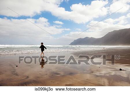 Boy running on a beach View Large Photo Image Picture - Boy running on a beach. Fotosearch