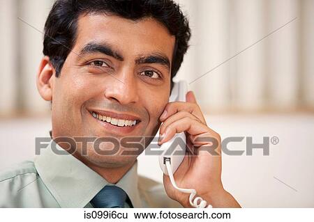 Business executive talking on the phone View Large Photo Image Stock Photograph - Business executive talking on the phone. Fotosearch