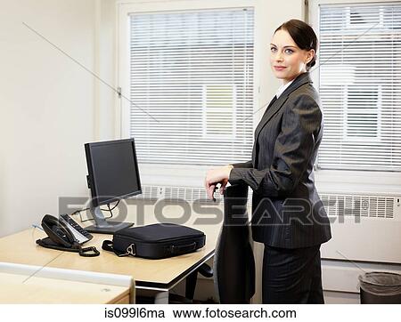 Stock Image - Businesswoman at her desk. Fotosearch