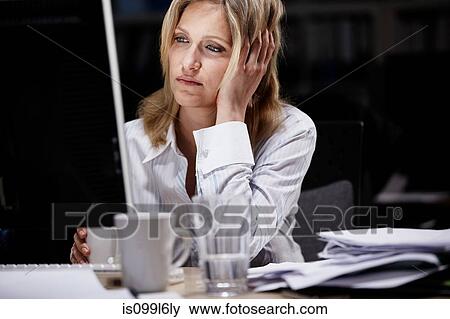 Stock Photo - Businesswoman working late. Fotosearch