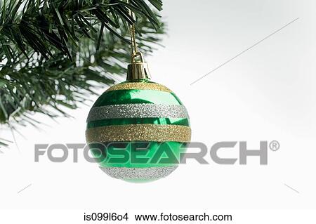 Christmas bauble hanging on tree View Large Photo Image Picture - Christmas bauble hanging on tree. Fotosearch